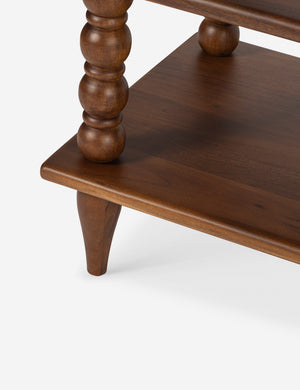 Close up of the bottom shelf of the Foxton beaded turned wood low bookcase