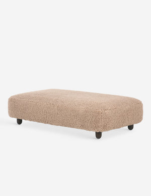 Angled view of the Dover faux shearline long ottoman.