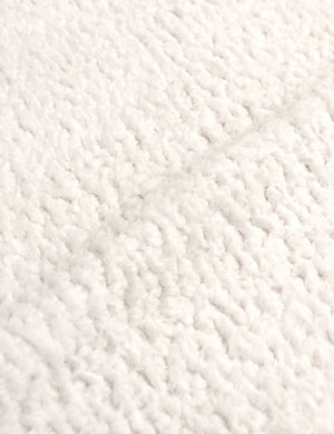 Detailed shot of the boucle fabric on the Adara cream sherpa upholstered bed.