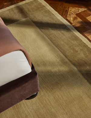 The Deller Hand-Loomed Wool Rug by Jake Arnold styled under a velvet bed frame