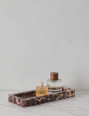 512 long scalloped decorative tray in cherry marble holding perfume bottles