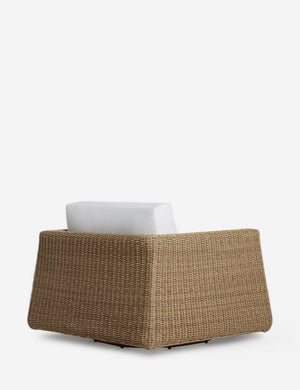Angled back view of the Aisha wide arm modern wicker outdoor swivel chair.