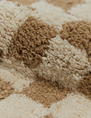 Close up view of the Two-tone checkerboard bath mat by Sarah Sherman in café brown