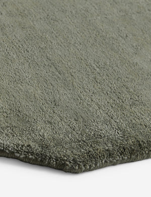 Close up of the corner of the Damara solid viscose rug in sage.