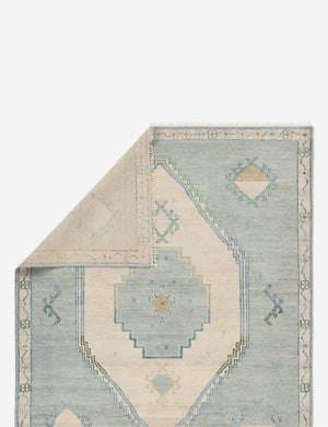 Folded corner showing the back of the Berker turkish-inspired hand-knotted wool rug.