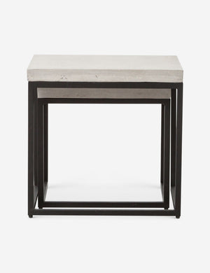 The Kallia indoor and outdoor nesting side tables with iron bases and concrete tops with the smaller table fully nested into the bigger table