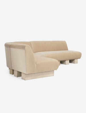 Angled view of the Lena left-facing beige velvet sectional sofa with upholstered beam legs.