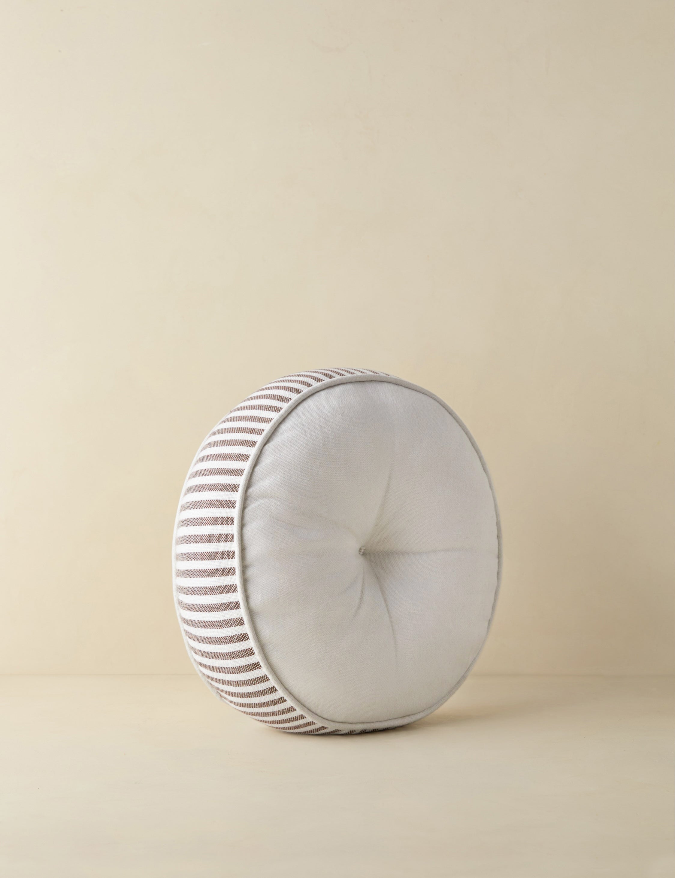 #color::brown | Angled view of the Littu Indoor / Outdoor Striped Disc Pillow by Sarah Sherman Samuel in Brown