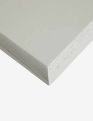 Close up of the corner of the Lowen double pedestal base white washed dining table.