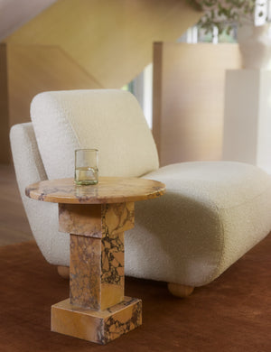 Kya textural boucle armless accent chair styled with a round orange marble side table.
