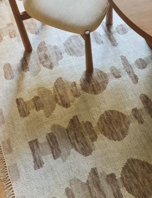 Yana hand-knotted organic pattern wool rug under a dining room chair.