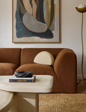 Sweeney half-disc silhouette abstract print throw pillow styled on a sofa.