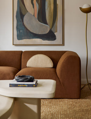 Sweeney half-disc silhouette abstract print throw pillow styled on a sofa.