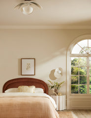| Soft Petal matte white floral silhouette flush mount light hung above a bed in a bedroom