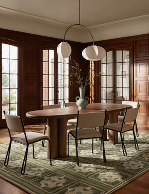 Luneth arc-shape lantern shade linear chandelier by Aimee Song hanging over a table in a dining room