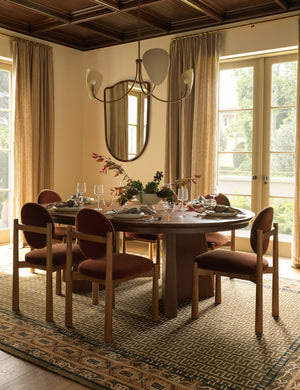 A dining room featuring the Manca traditional geometric motif hand-knotted wool rug.