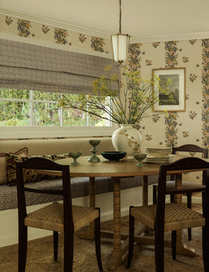 Frederick tapered glass shade chain pendant light by Heidi Caillier hung over a dining table