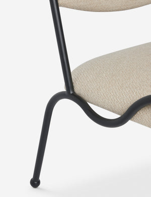 Close up view of the Fidia curved metal silhouette accent chair by Aimee Song