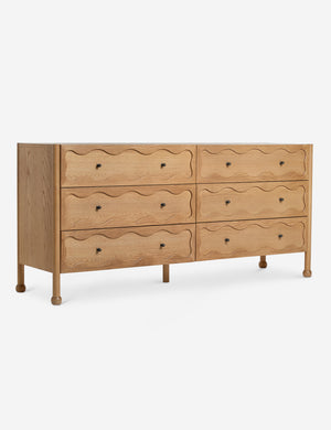 Angled view of the Fontaine wavy detailing solid oak 6-drawer dresser by Aimee Song