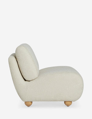 Side profile of the Kya textural boucle armless accent chair.