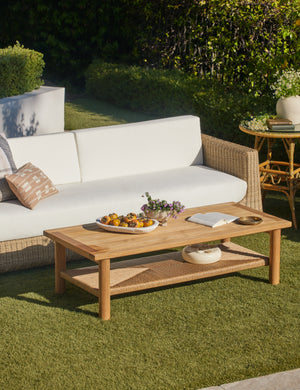 Gally teak and wicker outdoor coffee table and wicker outdoor sofa.