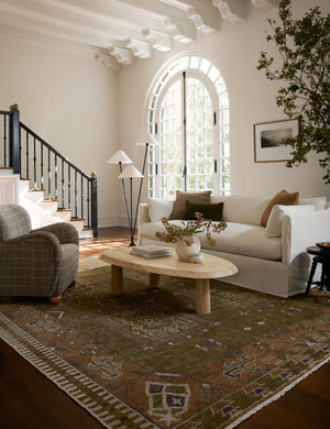 Living room featuring a white sofa, grid print upholstered accent chair and Rodolfo organic oval natural wood coffee table