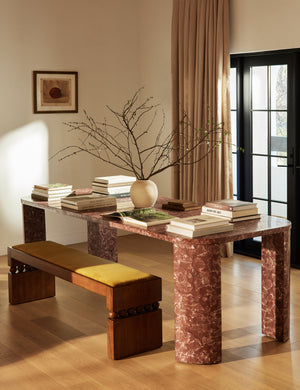 Ceiba mixed-material sculptural accent bench by Carly Cushnie styled with a rose marble dining table.