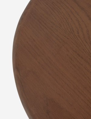 Close up view of the top of the Telle wavy leg solid wood round side table by Aimee Song