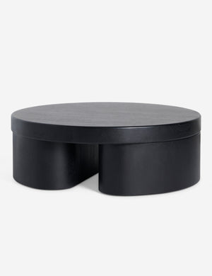 Angled view of Olga round modern black oak coffee table