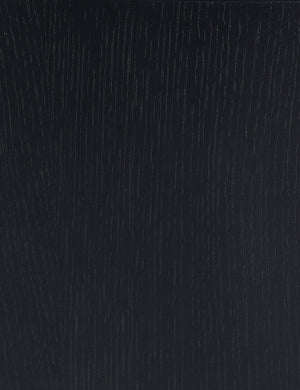 Close up view of the black oak wood grain of the Olga round coffee table