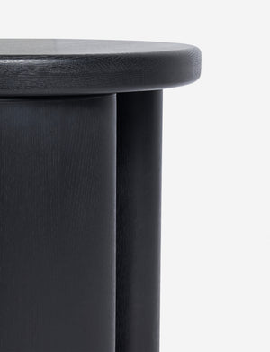 Close up view of the Olga round modern black oak side table