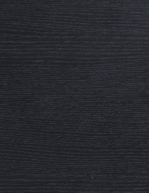 Close up view of the black oak wood grain of the Olga round side table