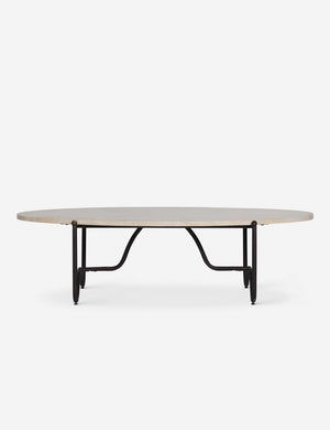 Side view of the Peggy sculptural iron frame and stone top oval outdoor coffee table.