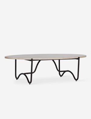 Peggy sculptural iron frame and stone top oval outdoor coffee table.