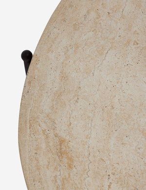 Close up of the top of the Peggy sculptural iron frame and stone top oval outdoor coffee table.