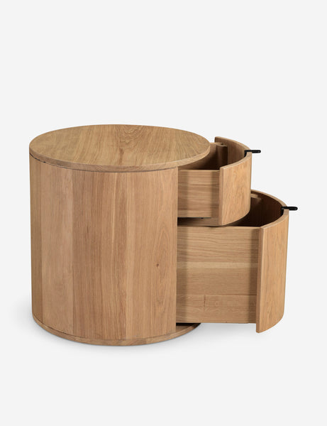 #color::natural | Side view of the Kono 2-drawer round oak nightstand with both drawers slightly opened.