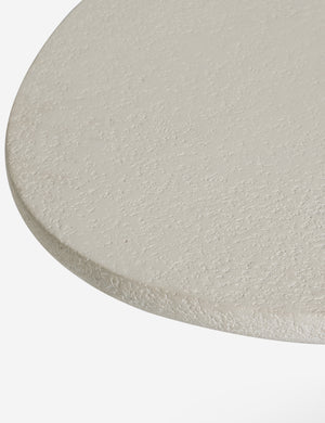 Close up of the Rodrigo sculptural oval outdoor dining table.