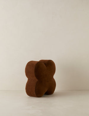 Angled view of the Velvet clover shaped accent pillow in cocoa