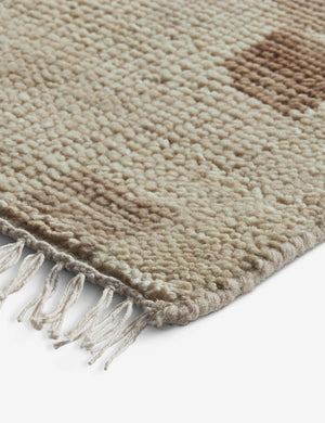 Close up of the corner of the Yana hand-knotted organic pattern wool rug.