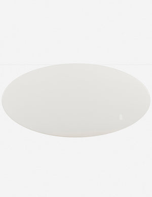 Bird's-eye view of the Thomas Bina oval coffee table with white laquered top, oak shelf and steel frame