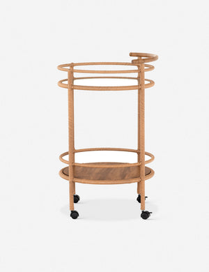 Side profile of the Annika round teak rolling outdoor bar cart.