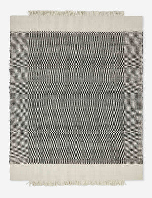 Joelle hand woven flatweave black and white checkerboard rug with an asymmetric fringe