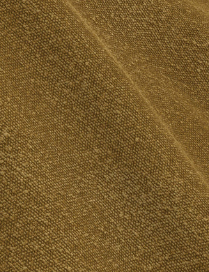 The ochre boucle fabric on the Nabiha platform bed