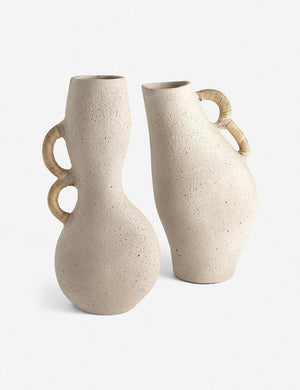Pisa natural toned organic vase with rattan wrapped handles stands next to another natural toned vase