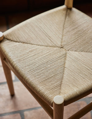 Close up view of the woven seat of the Nicholson slim natural oak wood frame and woven seat dining chair.