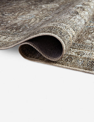 Close up of the Amalia distressed traditional rug folded over itself