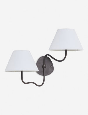Magdalene black double sconce with a white linen shade, a round wall mount, and an arched arm