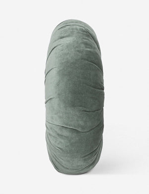 Side view of the Monroe shale blue velvet round pillow