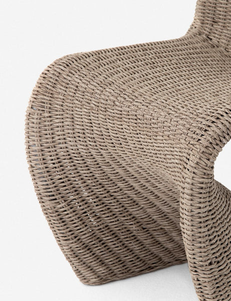 #color::vintage-white | Close-up of the scooped base on the Manila wicker weave beige indoor and outdoor dining chair