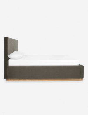 A side view of the Lockwood gray velvet-upholstered bed with a white oak base.